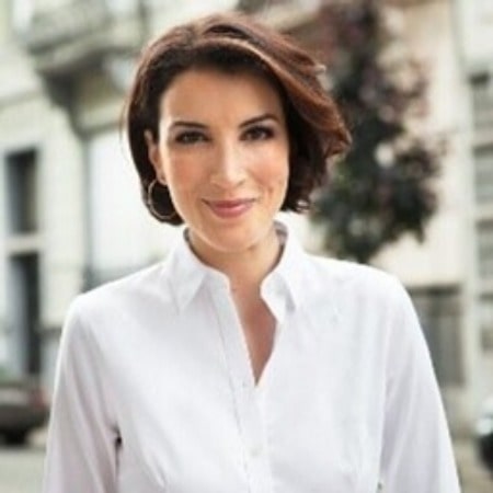 Laila Harrak posing for a photoshoot by wearing white shirt.